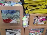a pile of clothes in a cardboard box on the floor