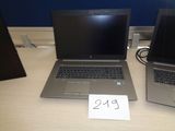 two laptops sitting on a table with a price tag on it