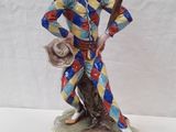 an image of a figurine of a clown holding a baseball bat