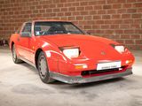 an image of a red sports car parked in a garage