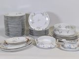 a lot of plates and cups and saucers on the table