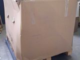 a cardboard box sitting on a pallet in a warehouse