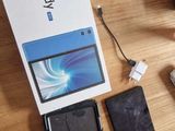a table with a laptop, a cell phone, a mouse, and a box on it