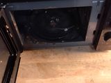 a microwave that is sitting on top of a wooden table