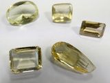 three yellow topazte and two green topazte faceted gems