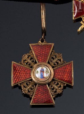 a red and gold cross with a picture of a woman on it