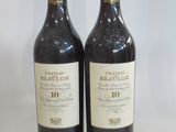 two bottles of red wine sitting next to each other on a table