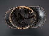 a close up of a black shoe with a hole in it