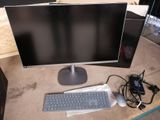a computer monitor and keyboard sitting on a desk