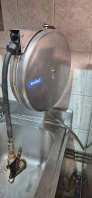 a metal sink with a metal faucet in it