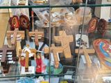 a glass case filled with wooden toys and religious items
