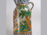 a vase that has a bird on it on a white background