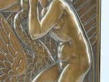 a metal plaque with an image of a man and a bird