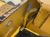 a close up of a yellow bulldozer on the ground