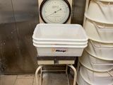 une pile de seaux posée à côté d'une horloge dans une pièce