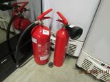 two fire extinguisors sitting next to each other on the floor