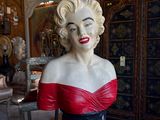 a busturine of a woman in a red dress in a store