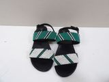 a pair of black sandals with green and white stripes