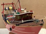 a model of a red boat on display on a table