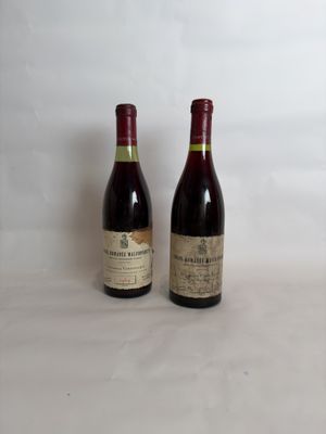 two bottles of wine sitting next to each other on a table