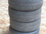 four tires stacked on top of each other on a tiled floor