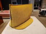 a yellow chair sitting on top of a mattress in a room