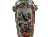 a vase with a bird and flowers on it on a white background