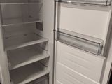 a white refrigerator with its door open in a kitchen