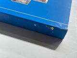 a blue box with pictures on it sitting on a table