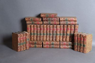 many books stacked on top of each other on a table