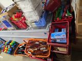 many boxes of supplies on the floor next to a refrigerator