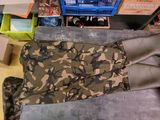 a pile of assorted clothing and other items on the floor