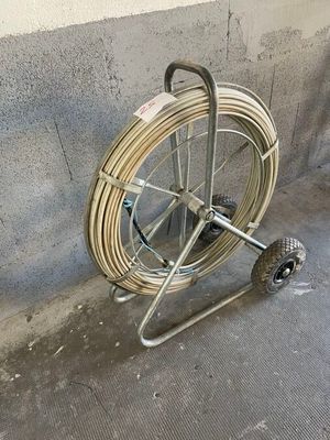 a cart with a hose attached to it on the sidewalk