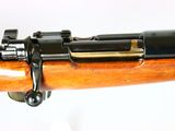 an image of a rifle with a wooden barrel on a white background