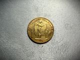 a gold coin sitting on top of a white surface