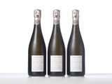 three bottles of wine sitting on top of a white table