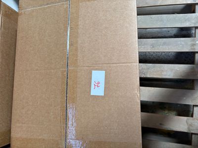 boxes are stacked on pallets in a warehouse with a sticker on them