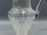 an image of a clear glass pitcher sitting on top of a table