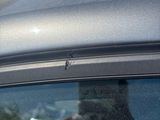 someone is taking a picture of the reflection of a man in a car