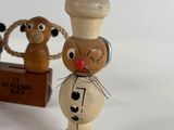 a small wooden toy of a mouse and a cat