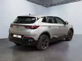 the rear end of a silver suv parked in a garage