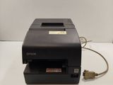 a black printer sitting on top of a white table next to a key