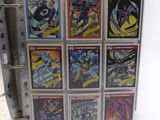 the batman comics are in a binder on a white surface