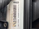 a close up of a car ' s engine with a barcode on it