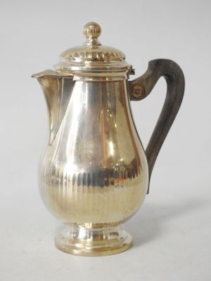 a silver coffee pot sitting on a white surface