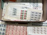 a suitcase full of stamps and stamps on a table