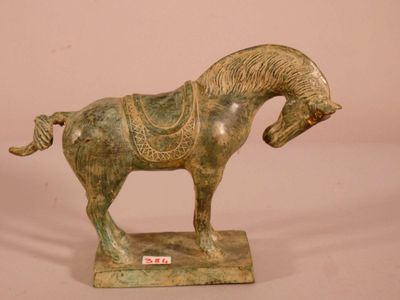 a statue of a horse with a saddle on it ' s back