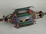 a metal teapot shaped like a boat with a handle