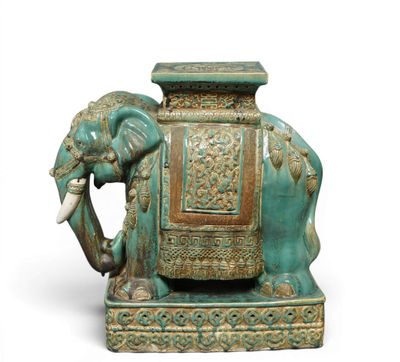 a statue of an elephant with a seat on it ' s back