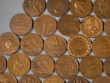 a lot of coins that are laying on a table